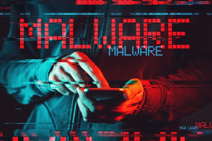 Malware concept with male person using smartphone Malware concept with male person using smartphone, low key red and blue lit image and digital glitch effect